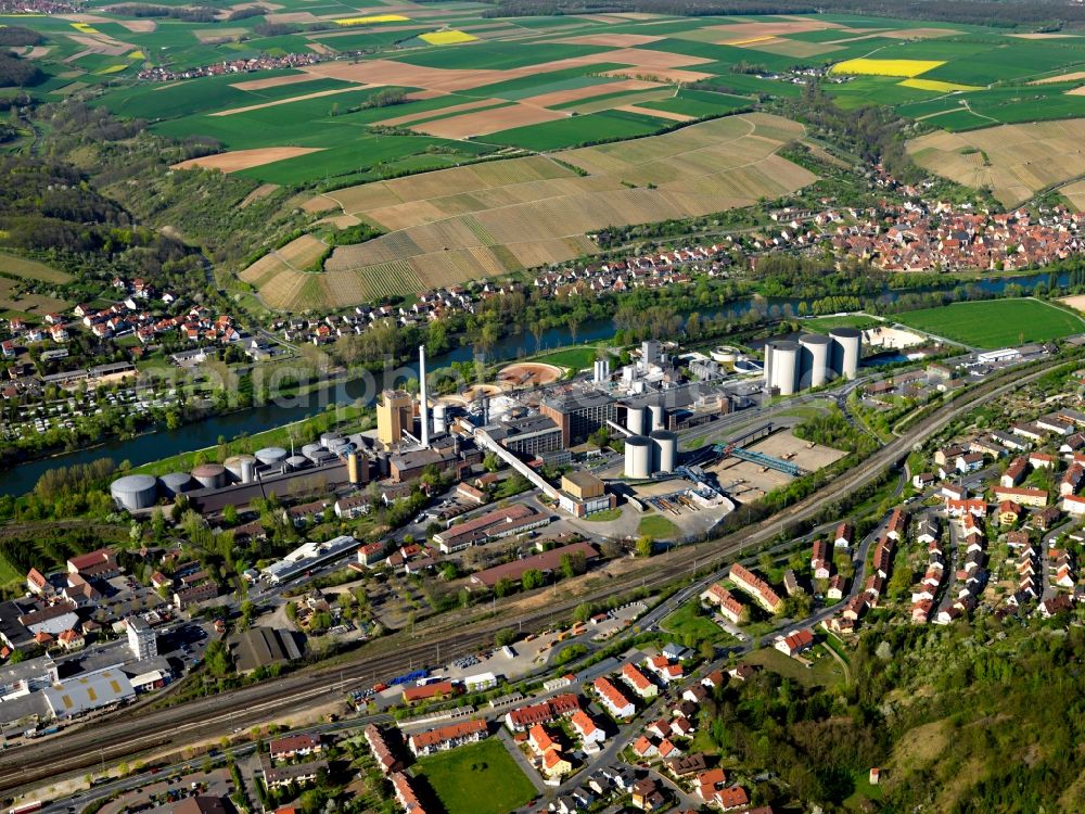 Ochsenfurt from the bird's eye view: The sugar factory in the town of Ochsenfurt in the district of Würzburg in Lower Franconia in the state of Bavaria. It is the third largest sugar factory, run by the Südzucker AG company. Ochsenfurt is located in the region of the Southern Main Triangle. The town and its surrounding landscape is characterised by the river, vineyards and the agricultural region of Ochensfurter Gau. The urban area consists of 16 city parts on both sides of the river
