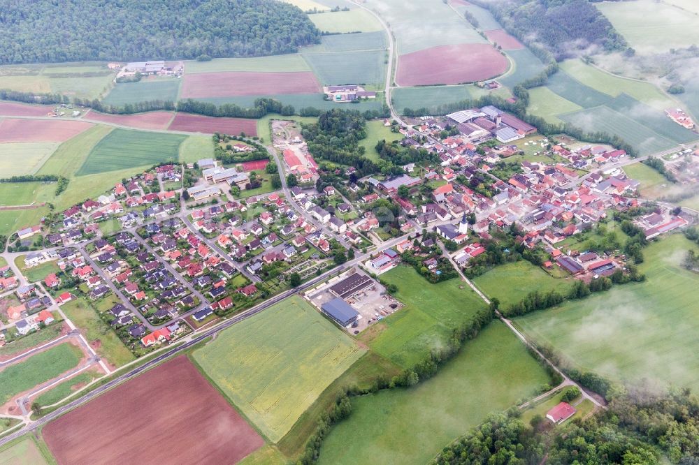Rauhenebrach from the bird's eye view: Village - view on the edge of agricultural fields and farmland in Rauhenebrach in the state Bavaria, Germany