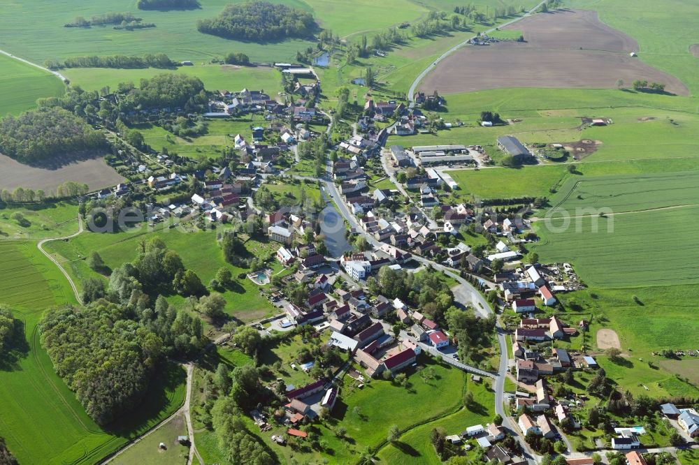 Bärnsdorf from above - Agricultural land and field borders surround the settlement area of the village in Baernsdorf in the state Saxony, Germany