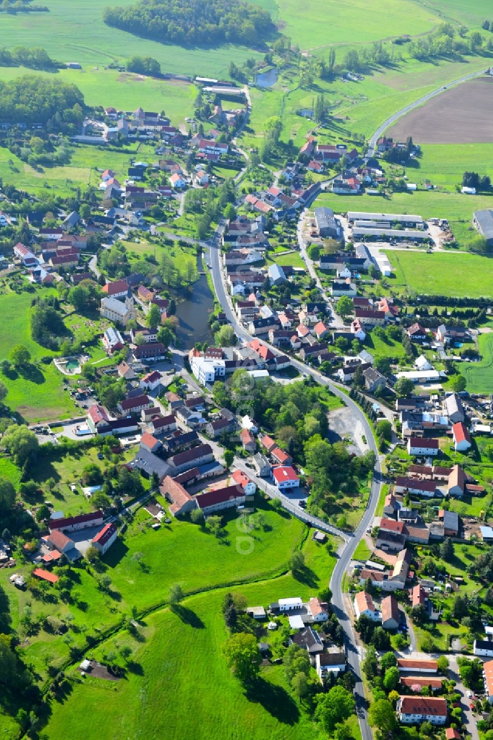 Aerial image Bärnsdorf - Agricultural land and field borders surround the settlement area of the village in Baernsdorf in the state Saxony, Germany