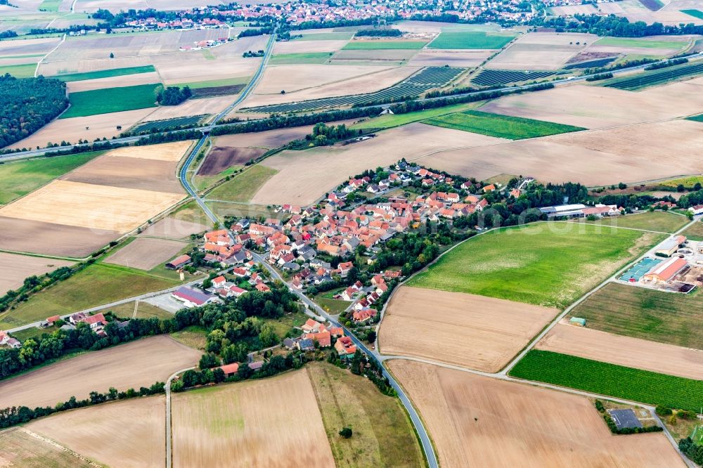 Feuerbach from above - Agricultural land and field borders surround the settlement area of the village in Feuerbach in the state Bavaria, Germany