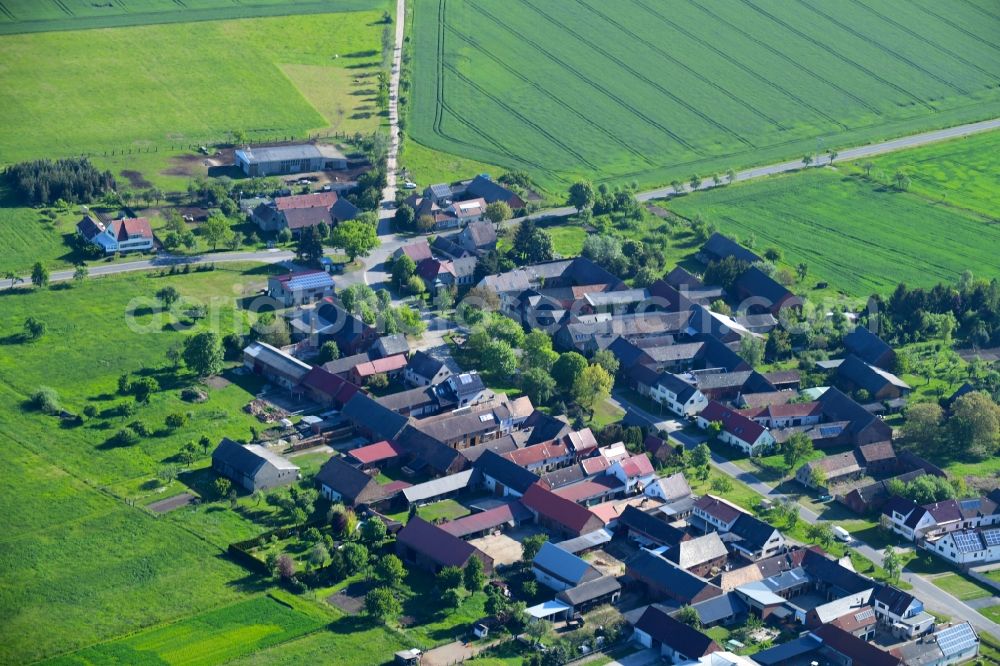 Aerial image Großbahren - Agricultural land and field borders surround the settlement area of the village in Grossbahren in the state Brandenburg, Germany