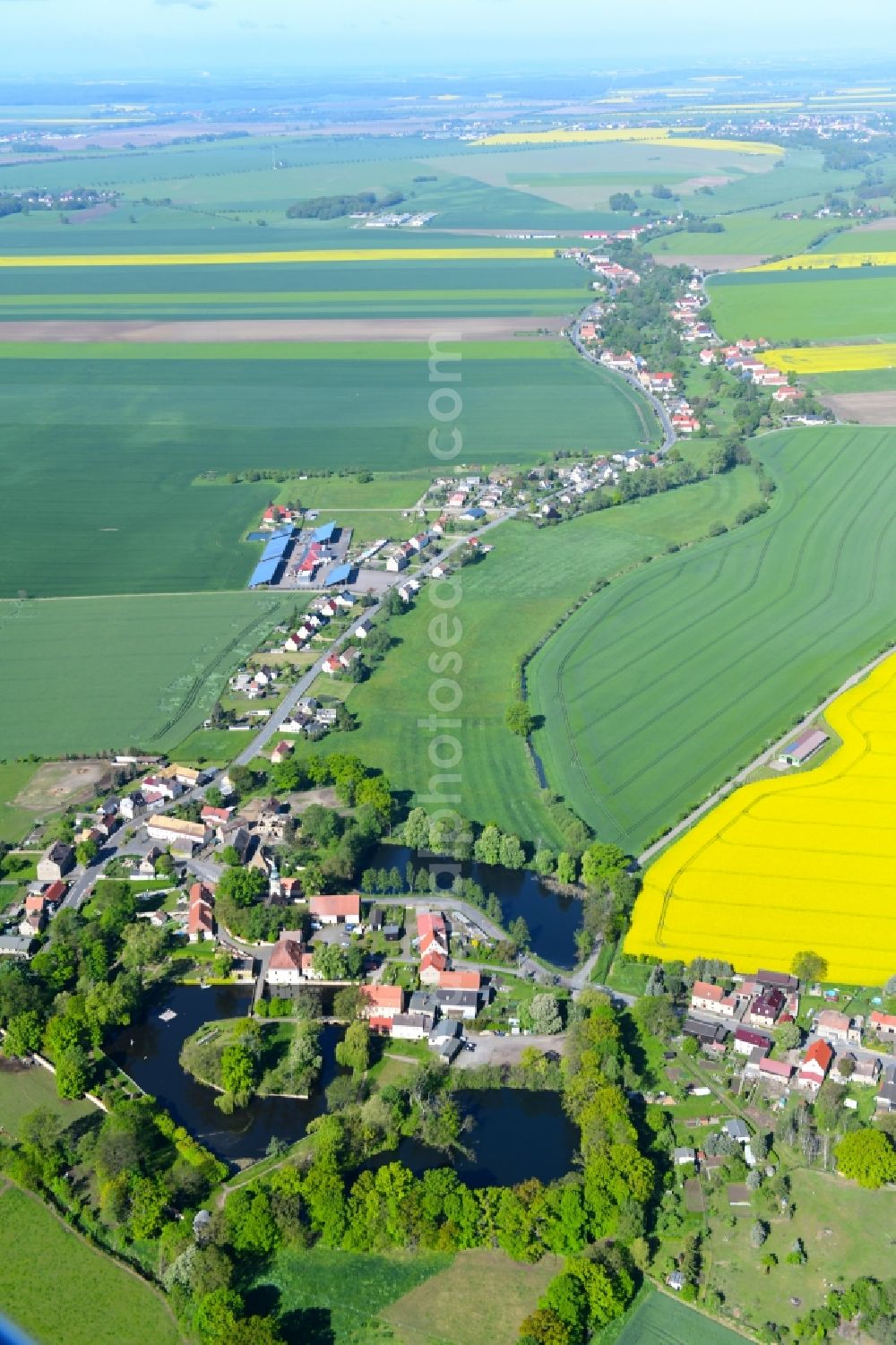 Lampertswalde from above - Agricultural land and field borders surround the settlement area of the village in Lampertswalde in the state Saxony, Germany