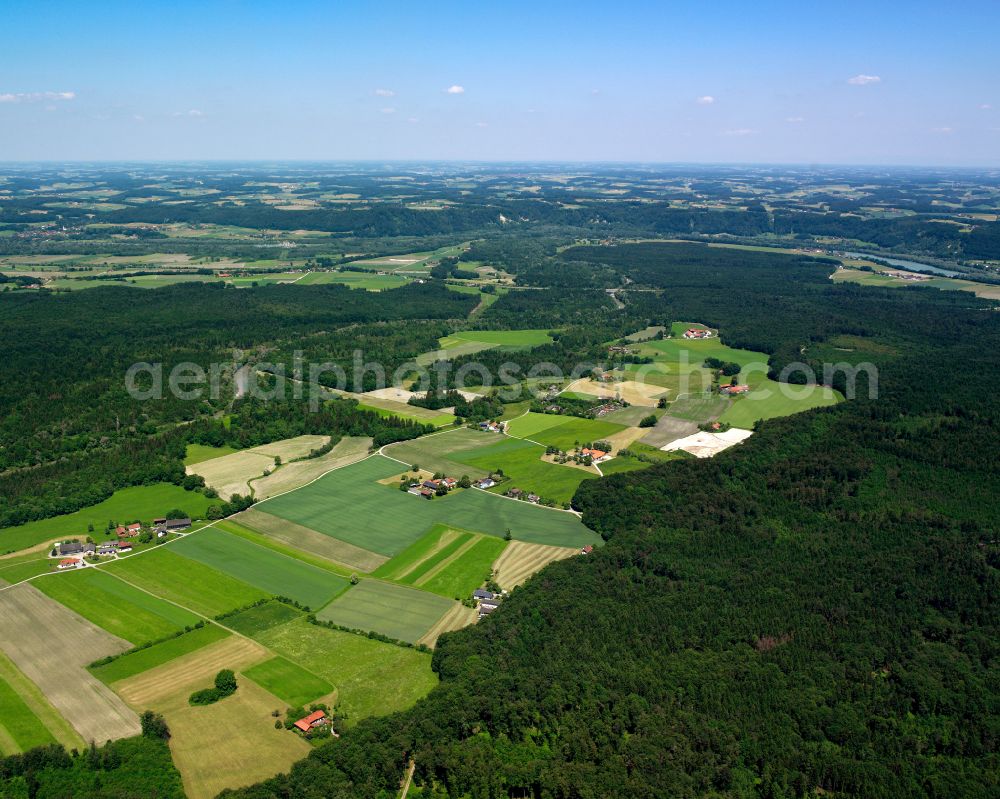 Schützing from the bird's eye view: Village - view on the edge of forested areas in Schützing in the state Bavaria, Germany