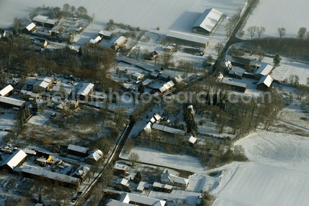 Altlandsberg from the bird's eye view: Snowy village view of Wegendorf near the land road L 235 in winter in the state Brandenburg
