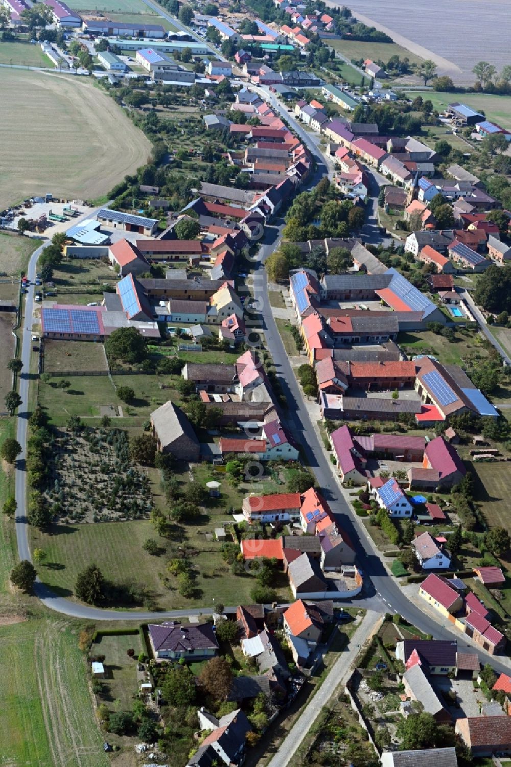 Aerial image Langenlipsdorf - Agricultural land and field borders surround the settlement area of the village in Langenlipsdorf in the state Brandenburg, Germany