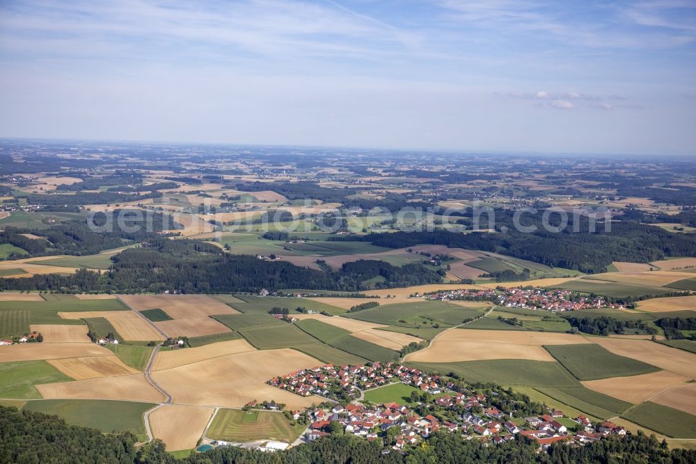 Aerial image Berghofen - Agricultural land, fields and forest surround the settlement area of a??a??the village in Berghofen in the state Bavaria, Germany