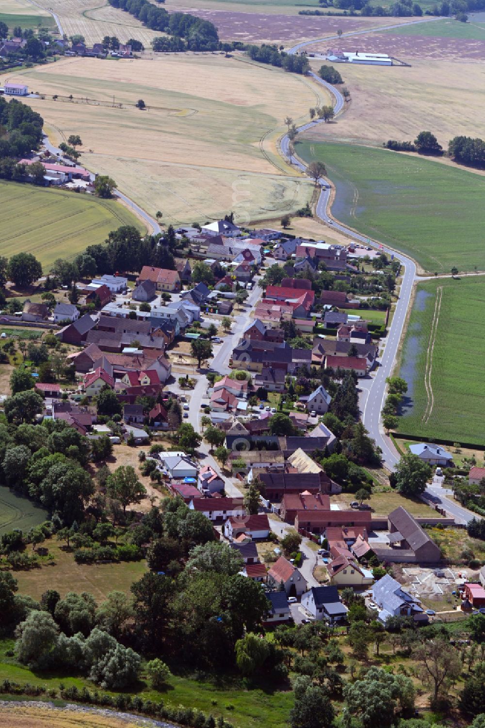 Zschepplin from the bird's eye view: Agricultural land and field boundaries surround the settlement area of the village in Zschepplin in the state Saxony, Germany
