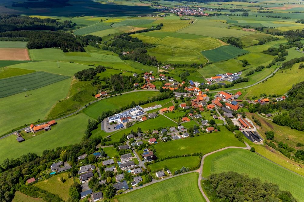 Aerial image Alraft - Agricultural land and field borders surround the settlement area of the village in Alraft in the state Hesse, Germany