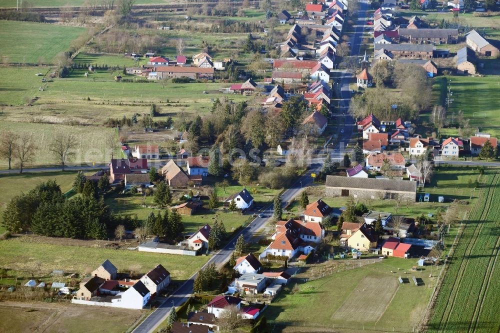 Altlüdersdorf from the bird's eye view: Agricultural land and field borders surround the settlement area of the village in Altluedersdorf in the state Brandenburg, Germany