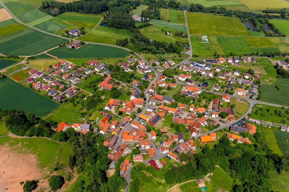 Aerial image Anraff - Agricultural land and field borders surround the settlement area of the village in Anraff in the state Hesse, Germany