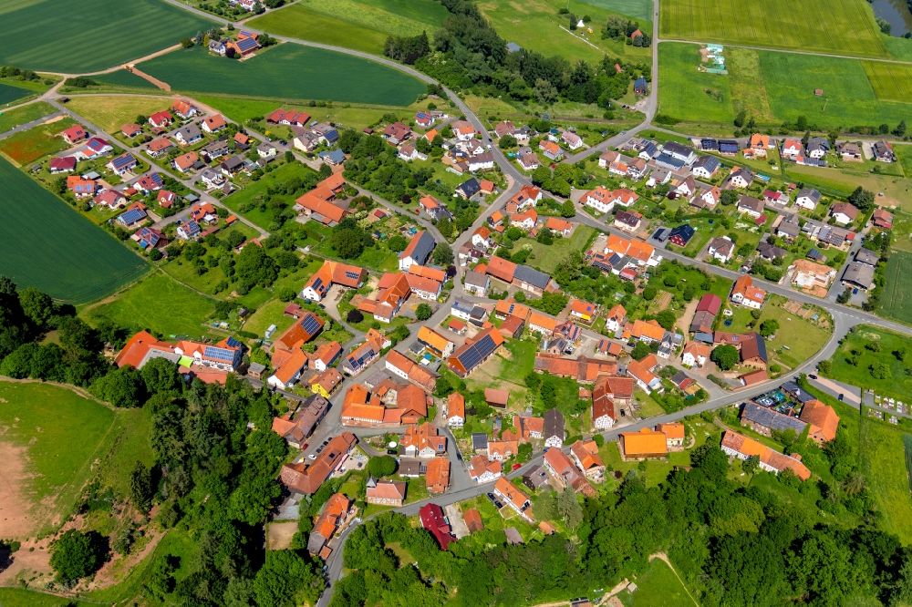 Aerial photograph Anraff - Agricultural land and field borders surround the settlement area of the village in Anraff in the state Hesse, Germany