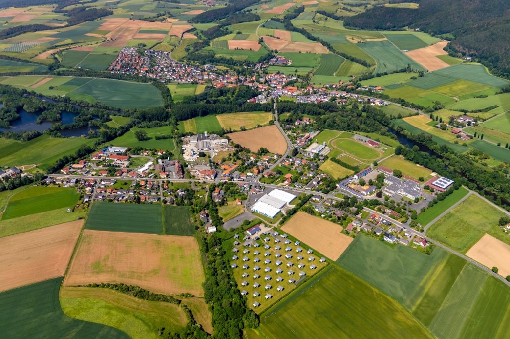 Bahnhof from the bird's eye view: Agricultural land and field borders surround the settlement area of the village in Bahnhof in the state Hesse, Germany