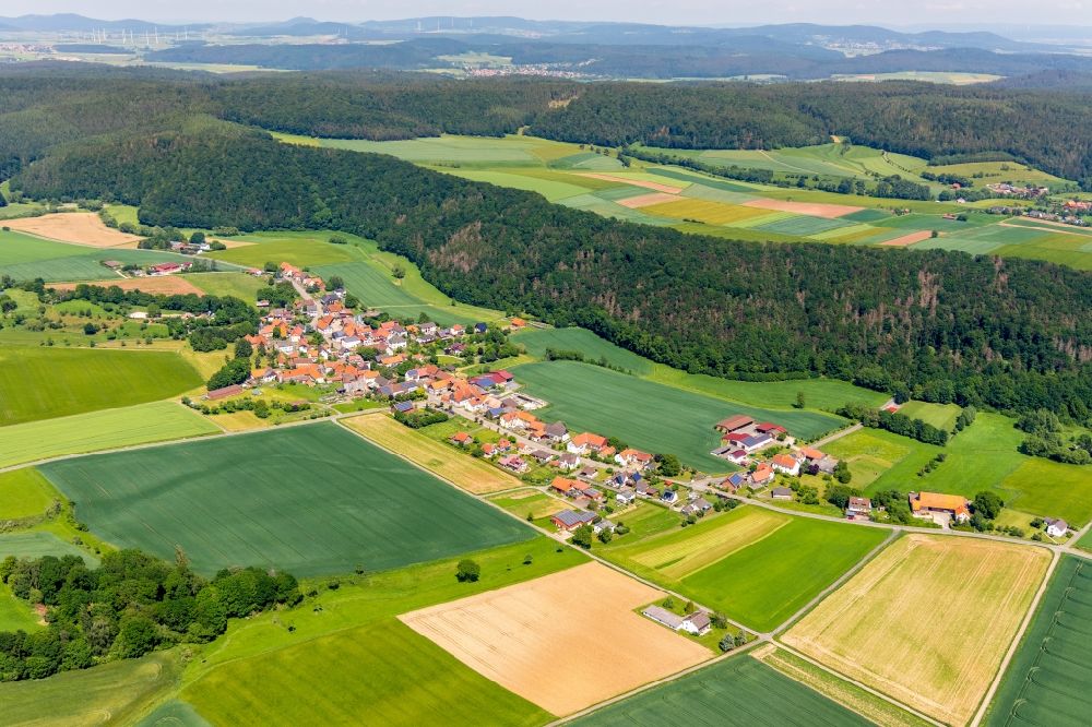 Aerial photograph Böhne - Agricultural land and field borders surround the settlement area of the village in Boehne in the state Hesse, Germany