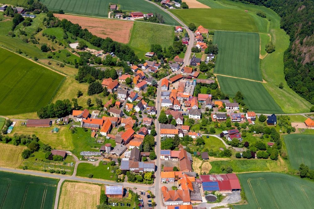 Aerial image Böhne - Agricultural land and field borders surround the settlement area of the village in Boehne in the state Hesse, Germany