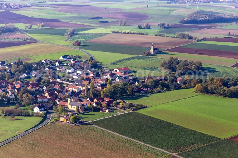 Bischwind from above - Agricultural land and field borders surround the settlement area of the village in Bischwind in the state Bavaria, Germany