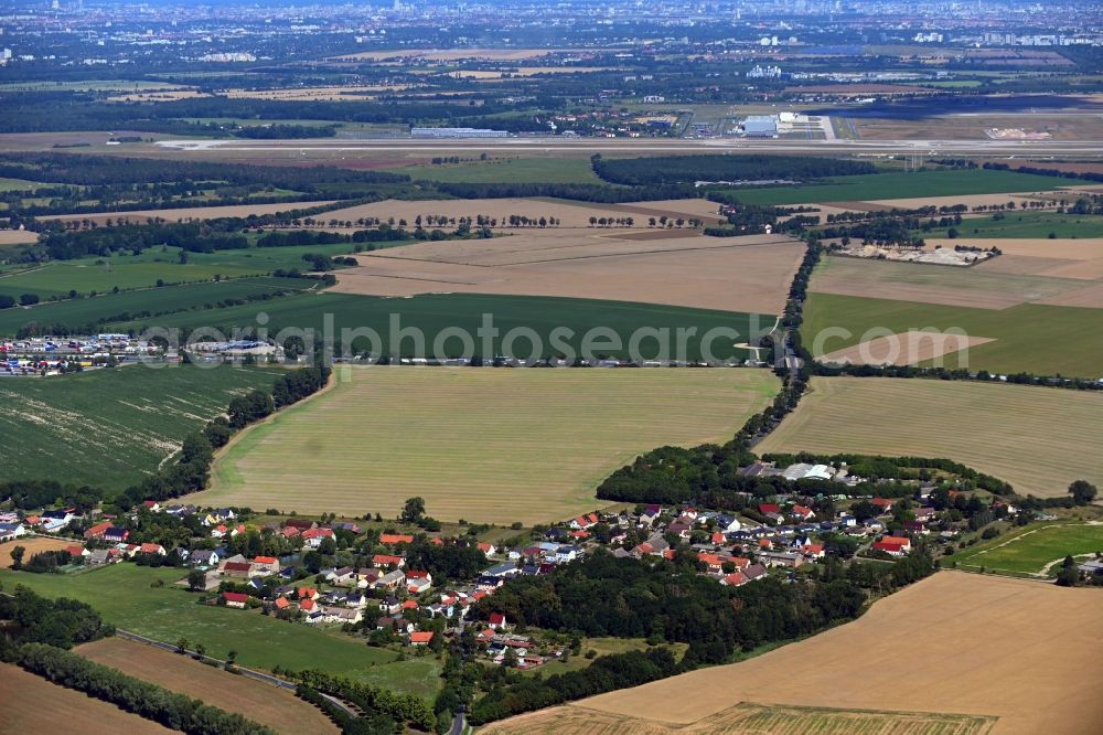 Brusendorf from above - Agricultural land and field borders surround the settlement area of the village in Brusendorf in the state Brandenburg, Germany