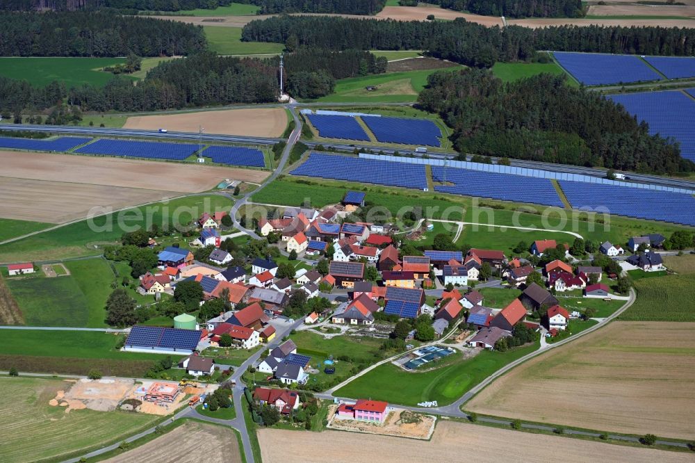 Buckendorf from above - Agricultural land and field borders surround the settlement area of the village in Buckendorf in the state Bavaria, Germany