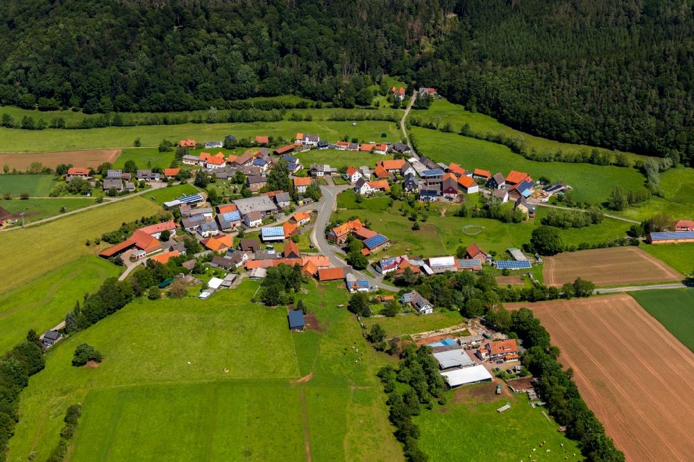 Aerial image Dehringhausen - Agricultural land and field borders surround the settlement area of the village in Dehringhausen in the state Hesse, Germany