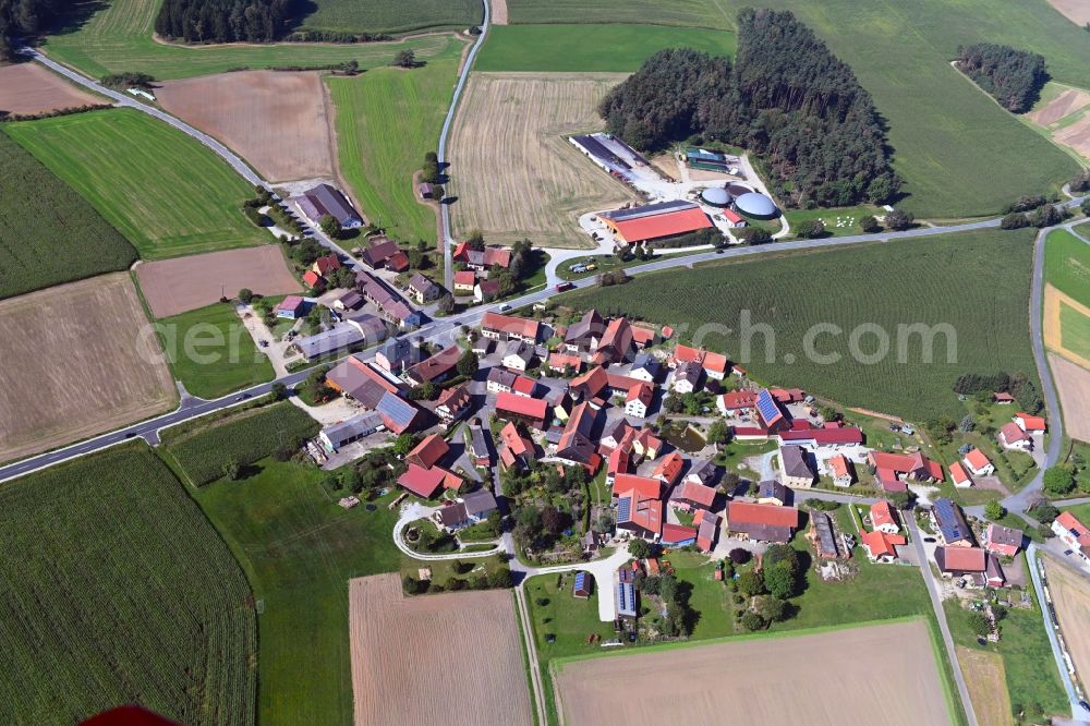 Eichenhüll from the bird's eye view: Agricultural land and field borders surround the settlement area of the village in Eichenhuell in the state Bavaria, Germany
