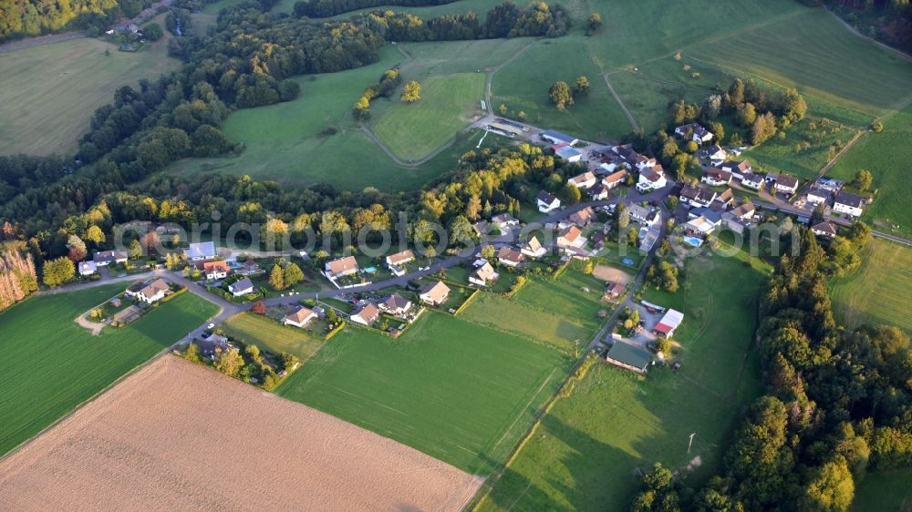 Eilenberg from above - Agricultural land and field borders surround the settlement area of the village in Eilenberg in the state Rhineland-Palatinate, Germany