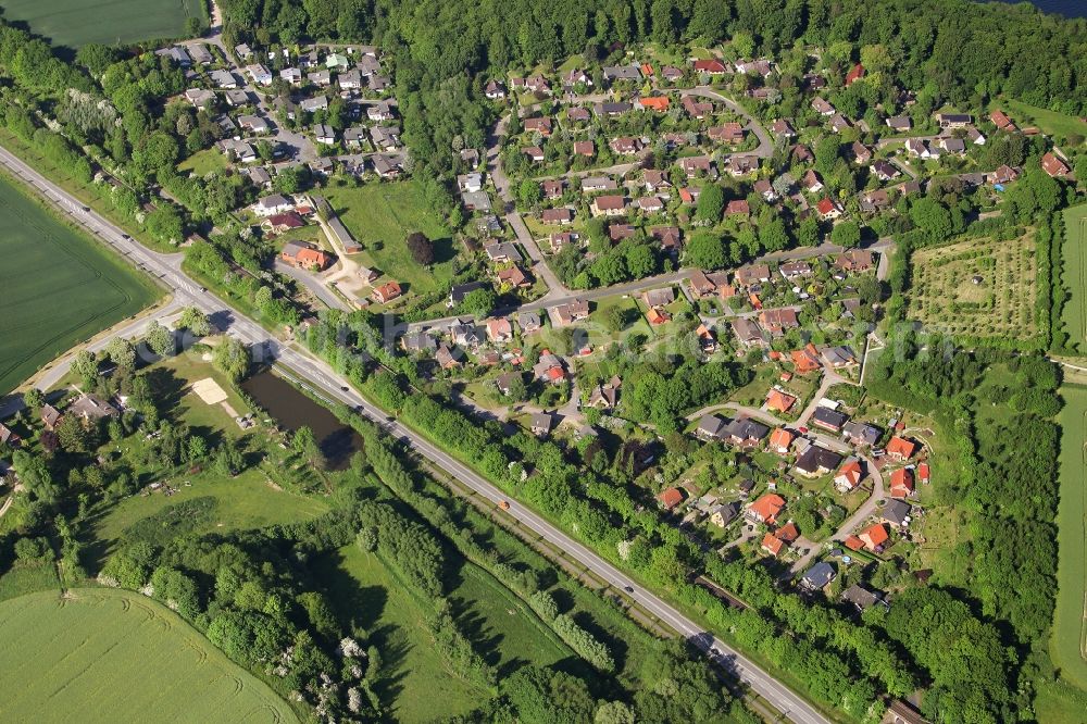 Einhaus from above - Agricultural land and field borders surround the settlement area of the village in Einhaus in the state Schleswig-Holstein, Germany