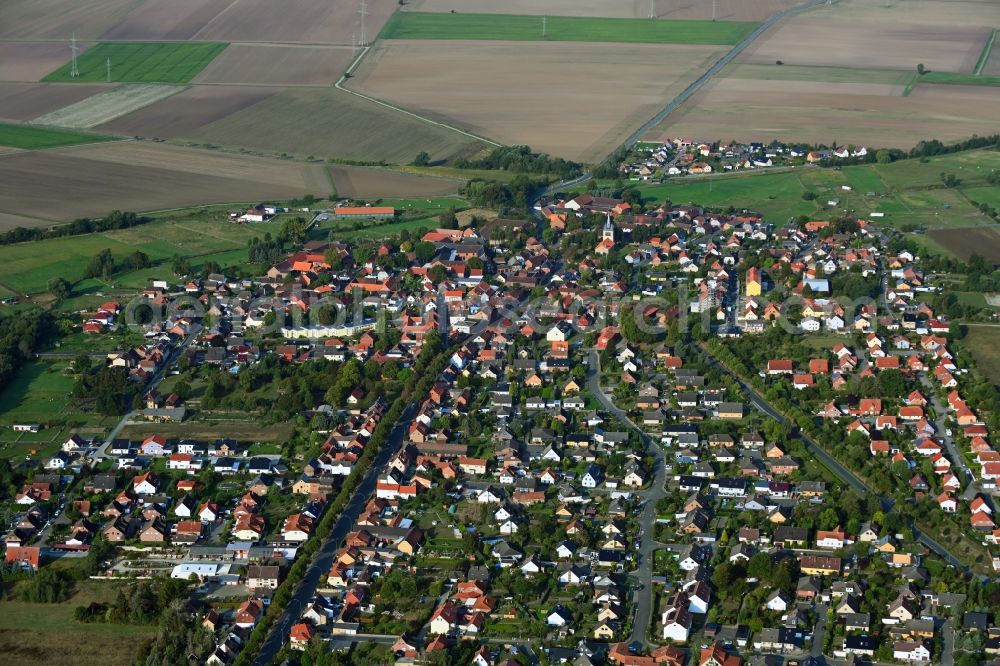Emmerstedt from the bird's eye view: Agricultural land and field borders surround the settlement area of the village in Emmerstedt in the state Lower Saxony, Germany