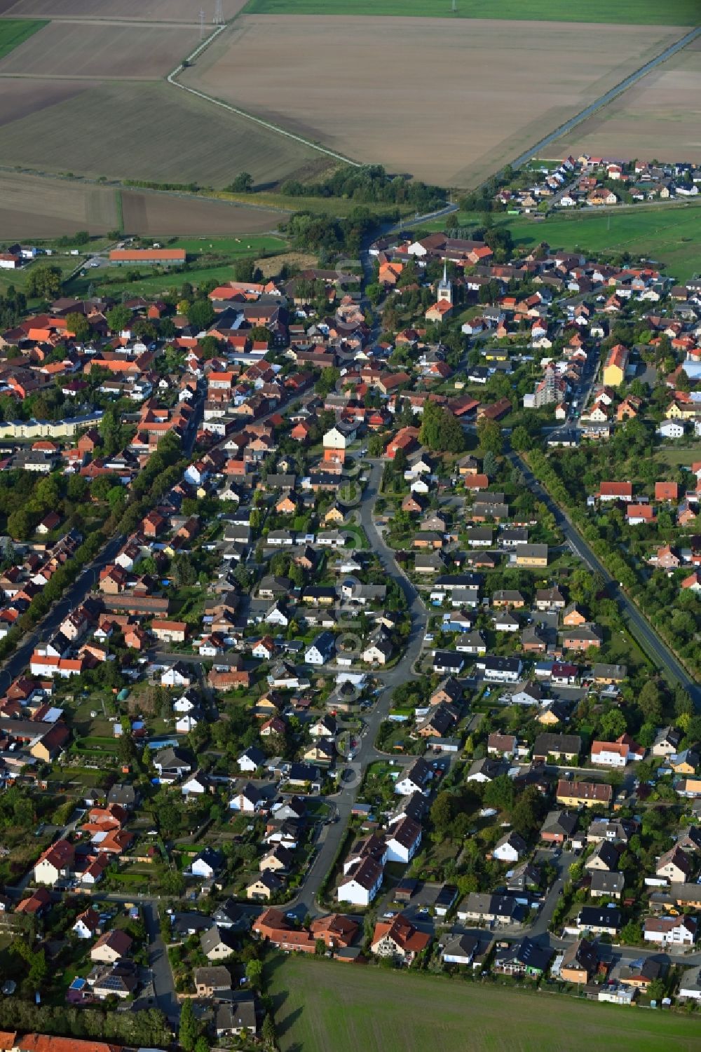 Aerial image Emmerstedt - Agricultural land and field borders surround the settlement area of the village in Emmerstedt in the state Lower Saxony, Germany