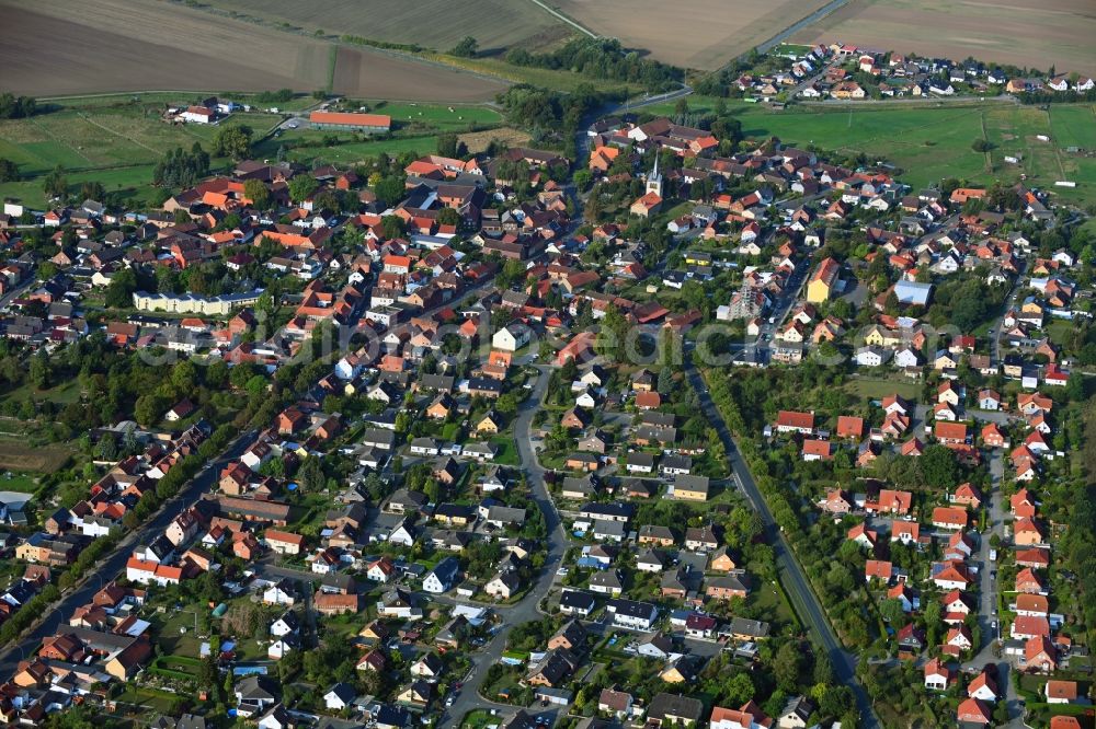 Aerial photograph Emmerstedt - Agricultural land and field borders surround the settlement area of the village in Emmerstedt in the state Lower Saxony, Germany