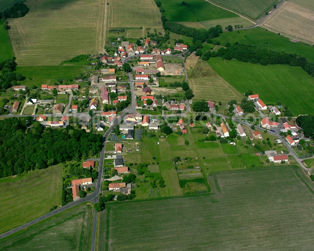 Adelsdorf from above - Agricultural land and field boundaries surround the settlement area of the village in Adelsdorf in the state Saxony, Germany