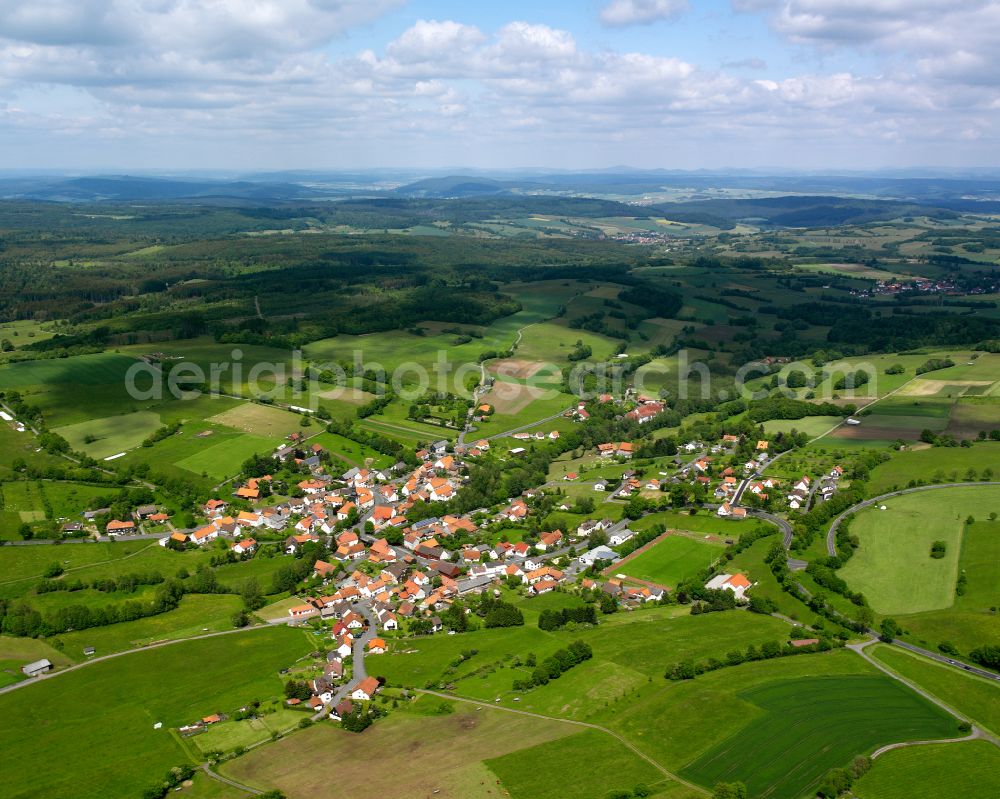 Altenschlirf from above - Agricultural land and field boundaries surround the settlement area of the village in Altenschlirf in the state Hesse, Germany