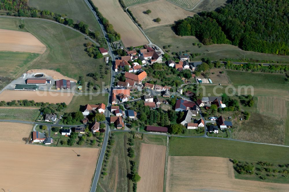 Aschenroth from above - Agricultural land and field boundaries surround the settlement area of the village in Aschenroth in the state Bavaria, Germany