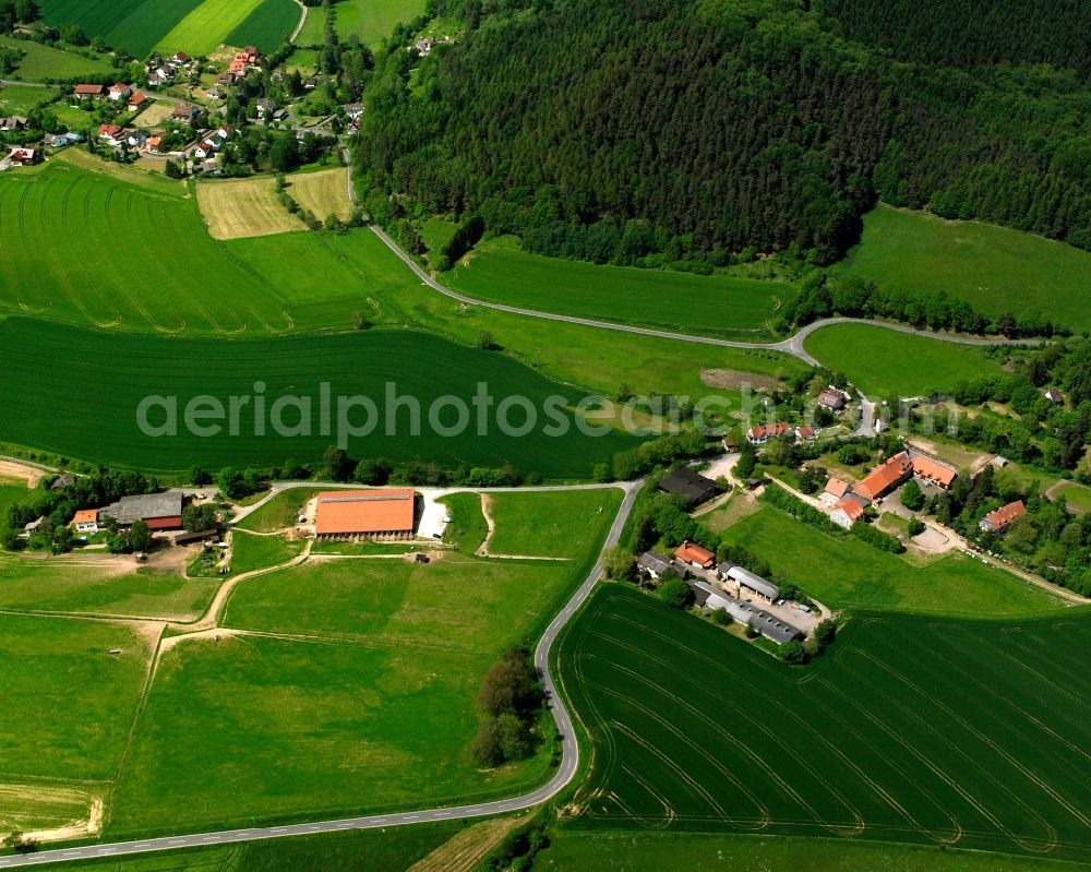 Aerial image Atzelrode - Agricultural land and field boundaries surround the settlement area of the village in Atzelrode in the state Hesse, Germany