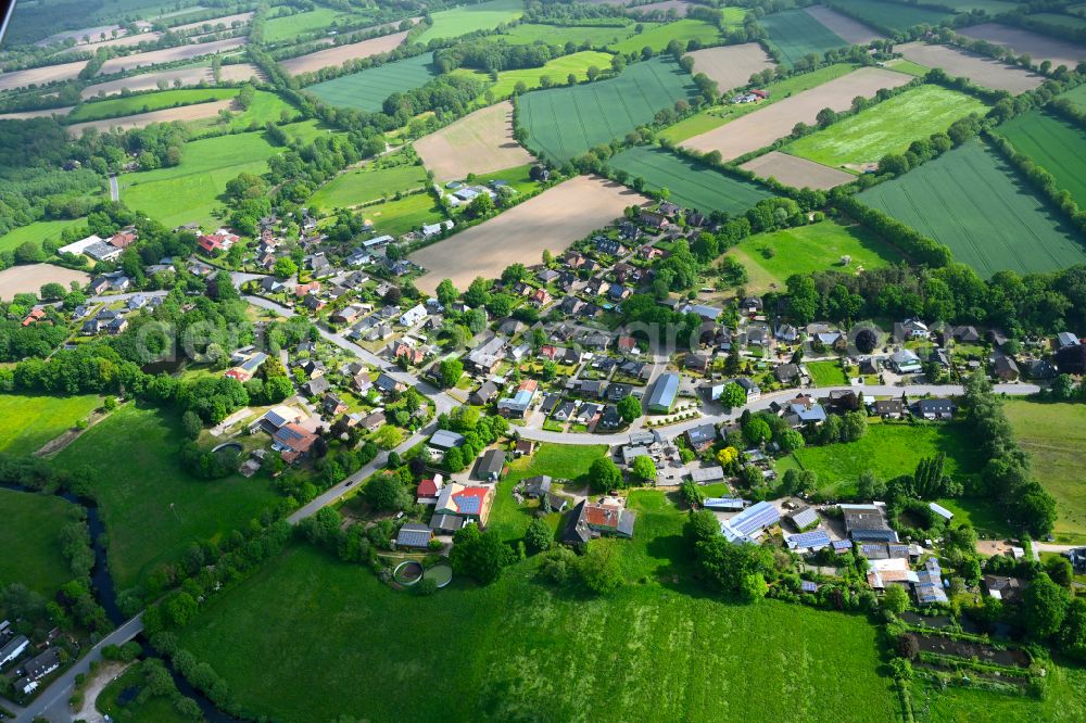 Aukamp from above - Agricultural land and field boundaries surround the settlement area of the village in Aukamp in the state Schleswig-Holstein, Germany