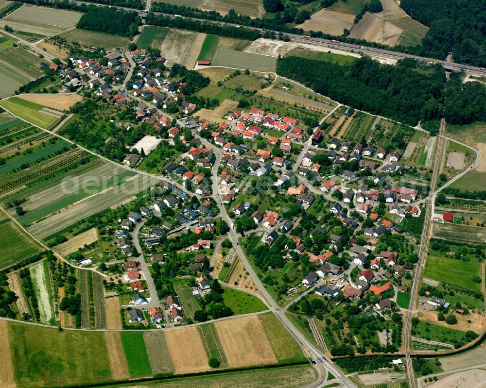 Balzhofen from above - Agricultural land and field boundaries surround the settlement area of the village in Balzhofen in the state Baden-Wuerttemberg, Germany
