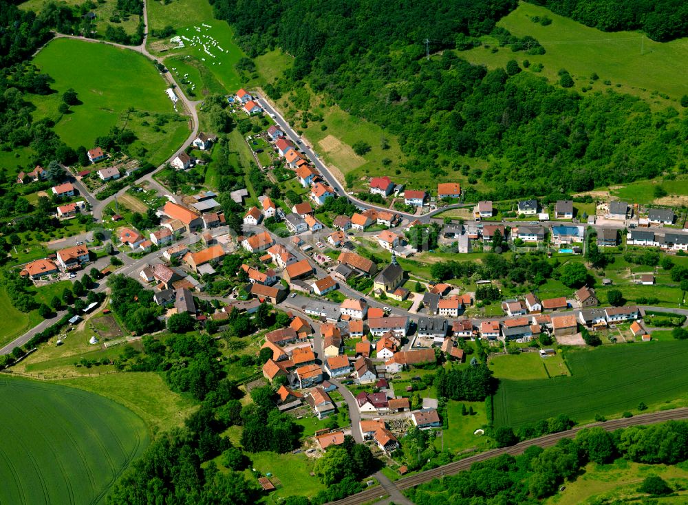 Bayerfeld from above - Agricultural land and field boundaries surround the settlement area of the village in Bayerfeld in the state Rhineland-Palatinate, Germany