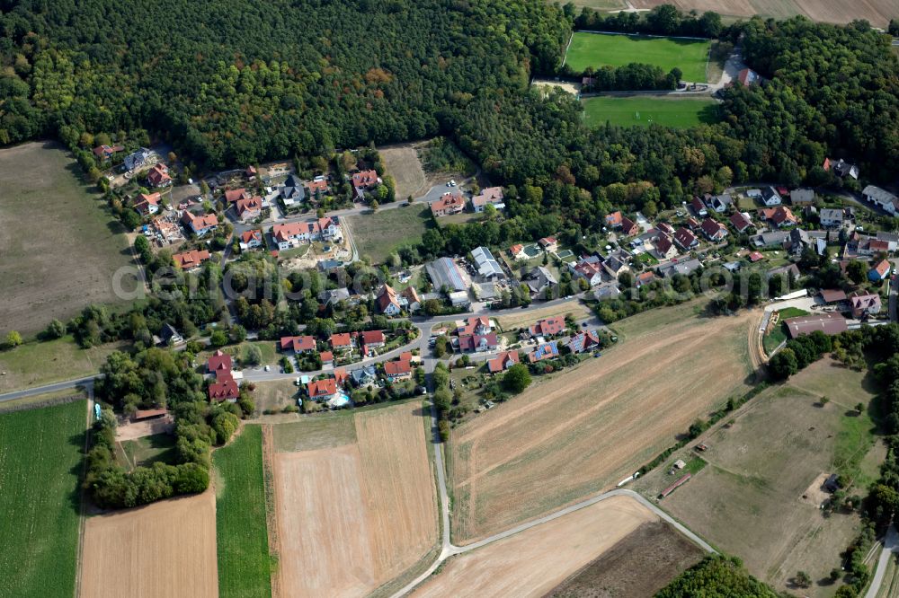 Büchold from above - Agricultural land and field boundaries surround the settlement area of the village in Büchold in the state Bavaria, Germany