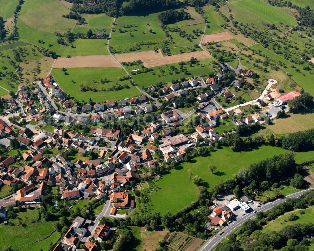 Beerfurth from above - Agricultural land and field boundaries surround the settlement area of the village in Beerfurth in the state Hesse, Germany