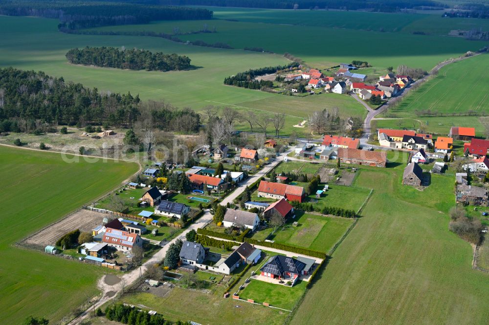 Benken from above - Agricultural land and field boundaries surround the settlement area of the village in Benken in the state Brandenburg, Germany