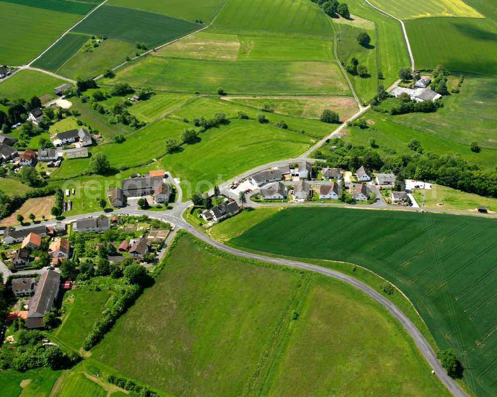 Berfa from above - Agricultural land and field boundaries surround the settlement area of the village in Berfa in the state Hesse, Germany
