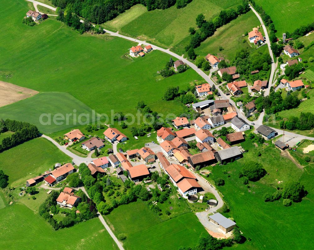 Aerial image Bernhardsberg - Agricultural land and field boundaries surround the settlement area of the village in Bernhardsberg in the state Bavaria, Germany