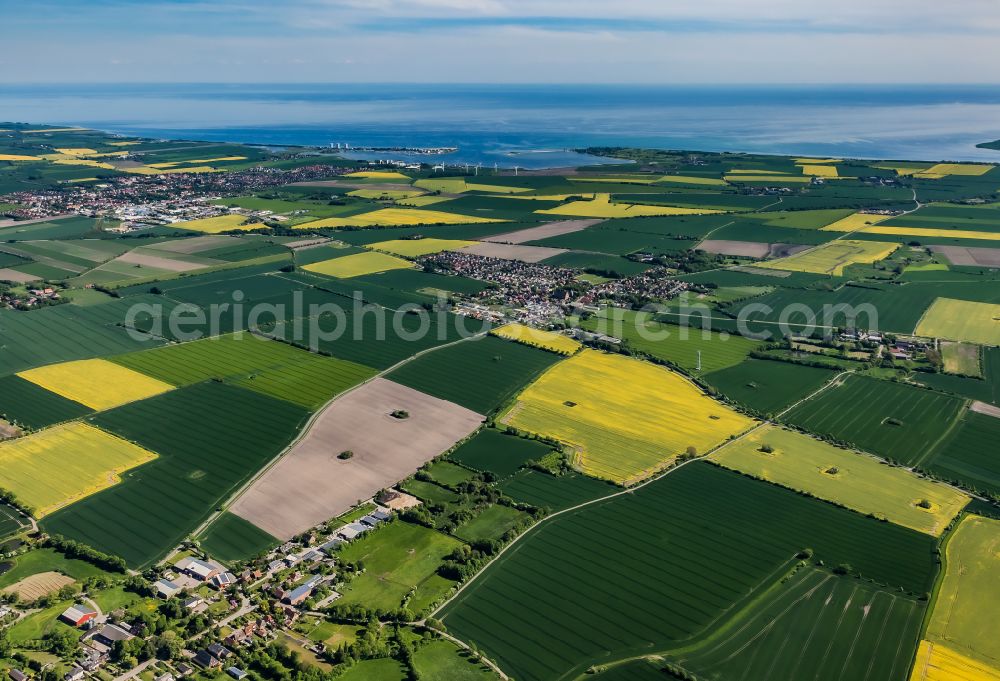 Fehmarn from above - Agricultural land and field boundaries surround the settlement area of the village in Bisdorf in Fehmarn on the island of Fehmarn in the state Schleswig-Holstein, Germany