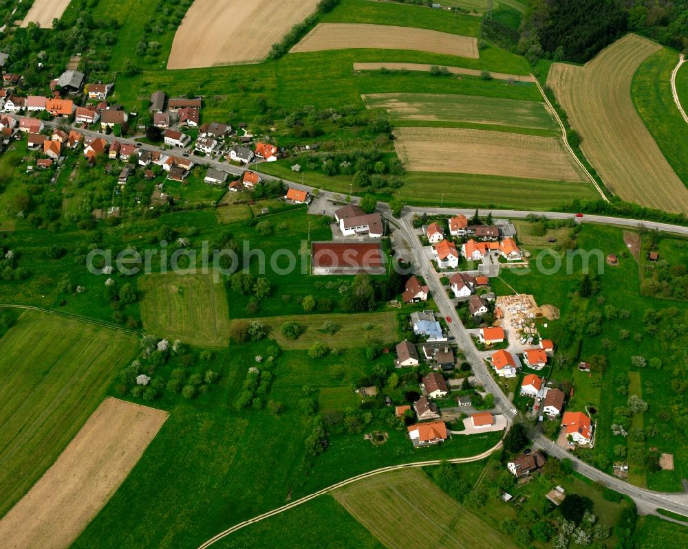 Bünzwangen from above - Agricultural land and field boundaries surround the settlement area of the village in Bünzwangen in the state Baden-Wuerttemberg, Germany