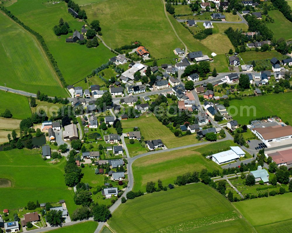 Bobengrün from above - Agricultural land and field boundaries surround the settlement area of the village in Bobengrün in the state Bavaria, Germany