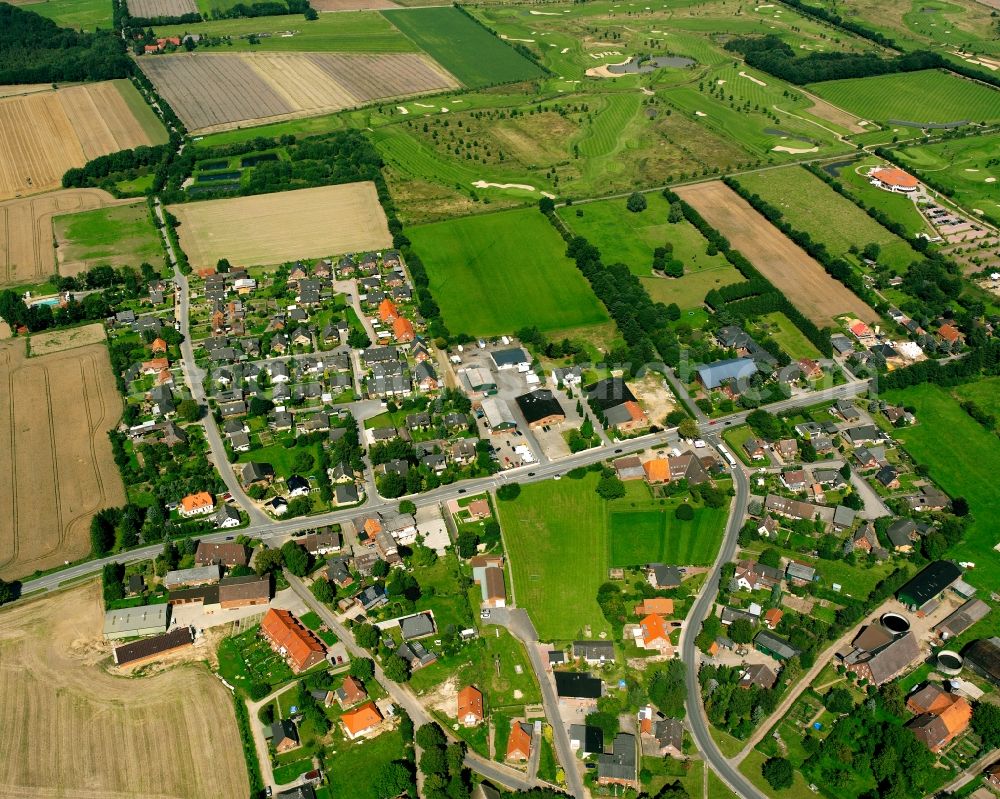 Aerial photograph Brunstorf - Agricultural land and field boundaries surround the settlement area of the village in Brunstorf in the state Schleswig-Holstein, Germany