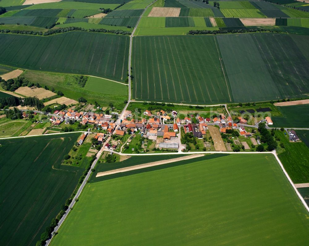 Böseckendorf from above - Agricultural land and field boundaries surround the settlement area of the village in Böseckendorf in the state Thuringia, Germany
