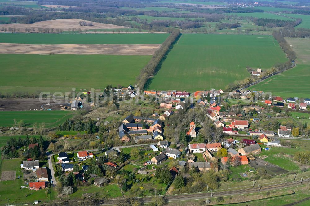 Buberow from the bird's eye view: Agricultural land and field boundaries surround the settlement area of the village in Buberow in the state Brandenburg, Germany