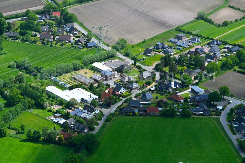 Bullenkuhlen from above - Agricultural land and field boundaries surround the settlement area of the village in Bullenkuhlen in the state Schleswig-Holstein, Germany