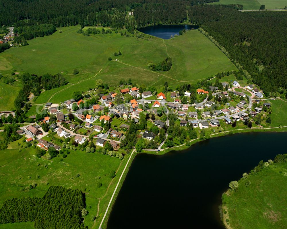 Aerial photograph Buntenbock - Agricultural land and field boundaries surround the settlement area of the village in Buntenbock in the state Lower Saxony, Germany