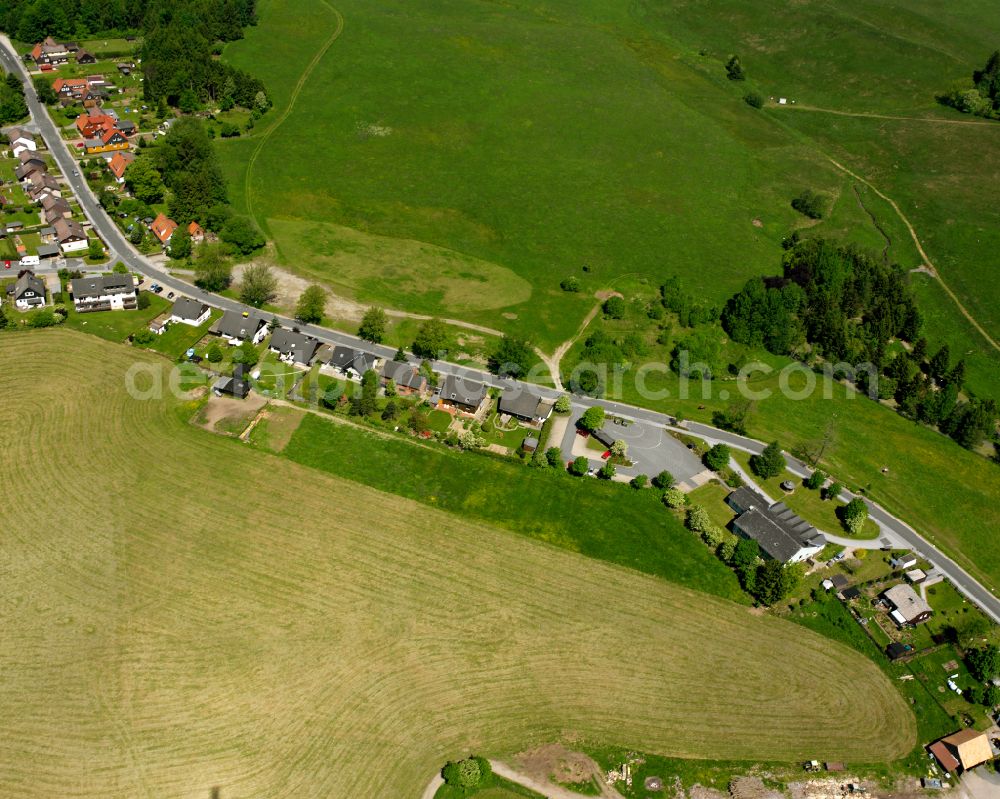 Buntenbock from above - Agricultural land and field boundaries surround the settlement area of the village in Buntenbock in the state Lower Saxony, Germany